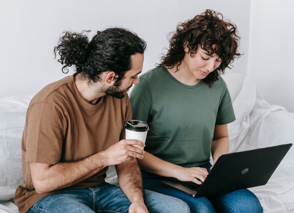 Couple reviewing information together on a laptop