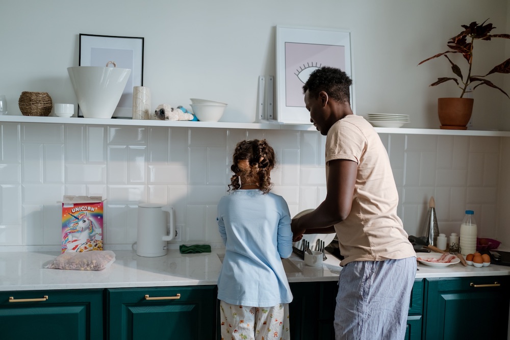 Parent and child preparing food together in the kitchen