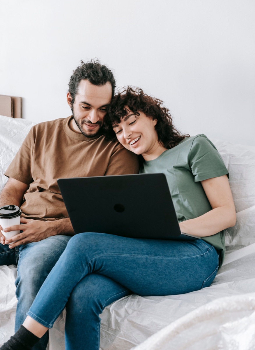 Couple planning together on a sofa with a tablet
